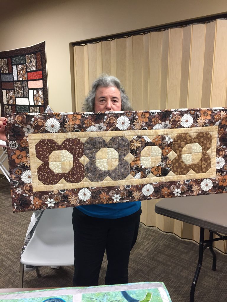 A brown flower table runner adds warmth to any room!